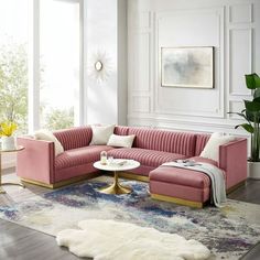 a living room with pink couches and white rugs