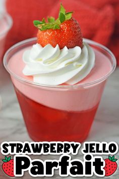 strawberry jello parfait with whipped cream and fresh strawberries in the background