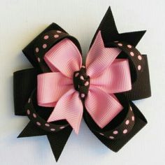 a pink and black bow with polka dots