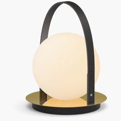 the lamp is shaped like an egg and has a black frame around it's base