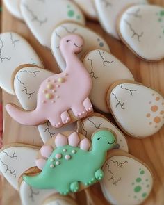 decorated cookies are arranged in the shape of dinosaurs