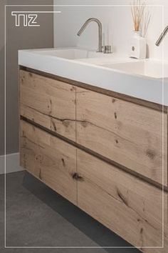 a bathroom with a sink and wooden cabinet in it's center area, along with the words tiz above it