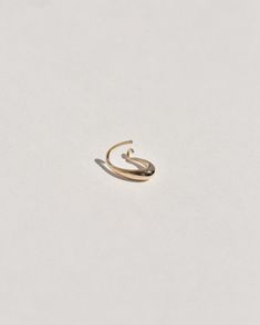 A semi-permanent style, the Sempre Hoop is part of a new offering of Leigh Miller that is designed to be worn everyday- or 'sempre'- which means always in Portuguese and Italian. This sculptural, solid gold hoop is intended to be put in, and never taken off. Wear it in the shower, in the pool or to sleep. Simply slide it in and fold the arm into its hook. Leigh was inspired to design this series to be the perfect huggers to compliment the rest of our sculptural earrings. The Sempre is ideal for Lobe Piercing, Statement Choker Necklace, Ear Cuffs, Fine Jewellery Earrings, Gold Hoop, Ring Bracelet, Ring Necklace, Statement Earrings, Ear Cuff