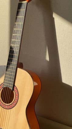 an acoustic guitar sitting on top of a table