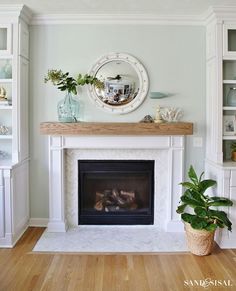 a living room filled with furniture and a fire place under a clock mounted on the wall