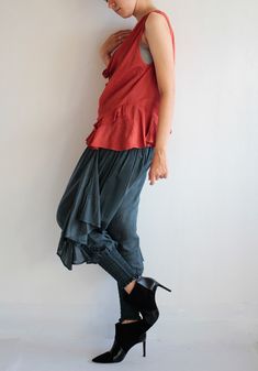 "Beautiful tank top/blouse that is great to pair with many of our pants. Sleeveless, cowl neck style, which can also be worn off the shoulder (picture 2) A loose fit, with great ruffled detail on the hem from the front to the back. Asymmetrical length. Wide armholes which also allow you to layer the piece over long sleeve/turtle neck for winter. Love the funky pants in the picture? Check out our wide range here: http://www.etsy.com/shop/cocoricooo/search?search_query=funky+pants&search_submi Casual Sleeveless Silk Top, Sleeveless Blouse For Fall Layering, Casual Sleeveless Silk Tank Top, Casual Silk Sleeveless Tank Top, Casual Sleeveless Viscose Blouse, Casual Ruffled Camisole Blouse, Casual Sleeveless Blouse For Layering, Casual Sleeveless Rayon Blouse, Casual Drapey Blouse