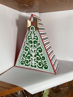 an origami christmas tree on top of a shelf