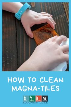 two hands on top of a wooden table with the title how to clean magna - tiles