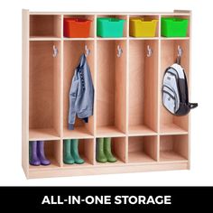 an all - in - one storage unit with several bins and two coats hanging on hooks