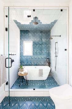 a white bath tub sitting under a bathroom window