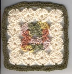 a crocheted square with flowers on it