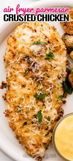 chicken parmesan is served on a white plate next to potatoes and dipping sauce