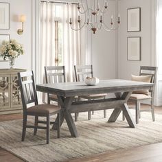 a dining room table with chairs and a bench