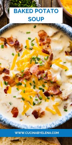 baked potato soup with bacon and cheese in a blue bowl on a wooden table next to bread