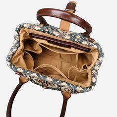 an open purse sitting on top of a wooden table