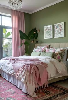 a bedroom with green walls, pink curtains and a large bed in the middle of it