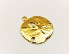 This vermeil sand dollar charm measures about 18mm in diameter. It is perfect for bracelet, necklace and earrings. It is 18k gold plated over 925 sterling silver (vermeil), shiny gold. 925 stamped in the back. 1 pc. silver version: Listing: http://www.etsy.com/listing/114478741/925-sterling-silver-oxidized-sand-dollar matte vermeil version: Listing: http://www.etsy.com/listing/150706144/vermeil18k-gold-over-925-sterling-silver For the larger quantity convo us. Thanks for stopping by! Gold Round Beach Jewelry, Gold Round Jewelry For Beach, Gold Round Jewelry For The Beach, Gold Pendant Jewelry With Starfish Charm, Handmade Gold Round Charms, Gold Round Pendant Jewelry For The Beach, Large Mermaid, Irish Claddagh, Gold Sand