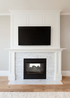 a fireplace with a flat screen tv above it