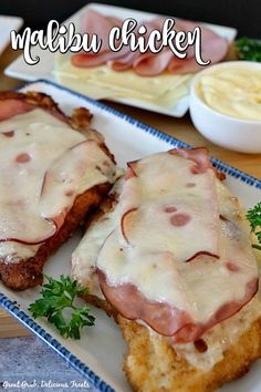 two pieces of meat covered in gravy sitting on a plate