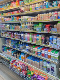 a grocery store filled with lots of different types of milk and juices on shelves