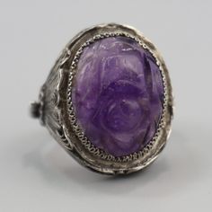 Beautiful Mid Century Carved Amethyst Ring Vintage, handcrafted iChinese export filigree ring. Carved amethyst cabochon in a sterling filigree setting. (Please note listing is for the single ring only - mixed photo is to give you an indication of proportions) Details: Band Size: 6 / M Setting Size: 2.5cm x 1.5cm Weight: 7 Grams Hallmark: SILVER (quite worn) Materials: Sterling Silver + Amethyst Condition Report: Spectacular vintage condition. Shows some wear to the filigree, will come with quite Ornate Amethyst Purple Ring, Ornate Purple Amethyst Ring, Vintage Amethyst Crystal Ring With Gemstone Detail, Antique Purple Amethyst Ring With Intricate Design, Vintage Amethyst Crystal Ring With Gemstone, Ornate Amethyst Gemstone Ring, Vintage Purple Crystal Ring, Handmade Vintage Amethyst Ring, Vintage Amethyst Ring Jewelry