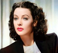 a close up of a person wearing a black jacket and white shirt with red lipstick