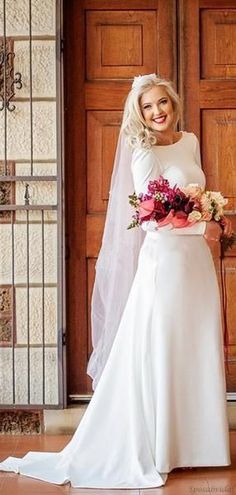 a woman in a white wedding dress holding a bouquet