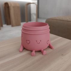 three pink bowls with hearts on them sitting on a table