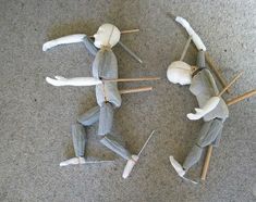 several puppets made to look like they are walking on the floor with sticks and wood