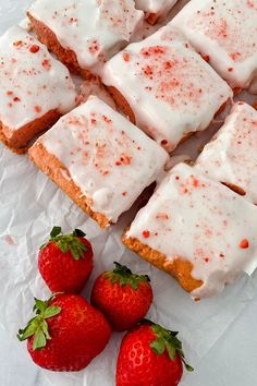 strawberry shortbreads with white frosting and strawberries on the side, ready to be eaten