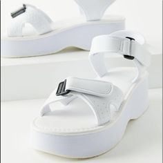 Jayna Sandal Features A Plushy Silhouette And Secure Strapping System. Platform Sole With A Cushioned Footbed Topped With Hook-And-Loop Straps That Adjust At The Toes And Ankle For An Easy On/Off. Exclusively Available At Urban Outfitters - 100% Rubber - Spot Clean - True To Size - Platform Height: 1.5" White Platform Sport Sandals For Beach, White Ankle Strap Sport Sandals For Summer, White Sport Sandals With Textured Footbed And Ankle Strap, White Ankle Strap Sport Sandals With Textured Footbed, White Synthetic Sport Sandals For Summer, White Sport Sandals For Spring And Summer, Trendy Urban Outfitters Summer Sandals, Urban Outfitters Sandals With Round Toe For Summer, Urban Outfitters Open Toe Synthetic Sandals