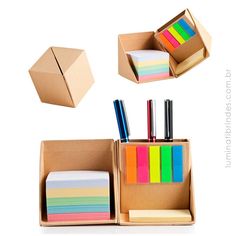 an open cardboard box with sticky notes and pens