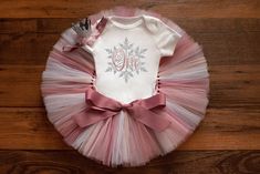 "The \"muted pinks\" winter onederland first birthday tutu set is made with layers of rosy mauve, rose, blush, and white tulle. This set has options for a matching crown headband, bodysuit, or the full three-piece set. Our tutus are made on a ribbon-tie waistband that ties and unties at the bow for a custom fit.  Click 'more' for sizing charts!  Headbands will always match the outfit and style pictured, but may come with a different color combination. If you're looking for something specific, pl Winter Onederland First Birthday Outfit, Winter Onederland Outfit Girl, Winter Onederland Party Girl Outfit, Winter Onederland First Birthday Cake, Winter Onederland Cake Smash, Winter First Birthday, Winter First Birthday Themes, Winter Onederland Outfit, Winter Onederland Cake