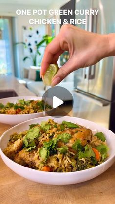 the person is cutting up some food in two bowls on the table with a knife