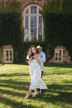 a man and woman standing in front of a building