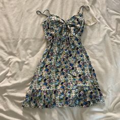 Very Gorgeous Vintage Vibe Flower Patterned Mini Dress! Size Medium In Perfect Condition. New With Tags! No Rips, Tears, Or Stains! Tie In The Front With A Triangle Cut Out! Blue Floral Print Sundress, Blue Ditsy Floral Print Dress For The Beach, Cute Floral Print V-neck Sundress, Purple Floral Print Sundress For Spring, Cute Mini Dress With Floral Print For Daytime, Casual Floral Print Mini Dress For Garden Party, Cute Floral Print Mini Dress For Daytime, Spring Purple Floral Print Sundress, Spring Floral Print Purple Sundress