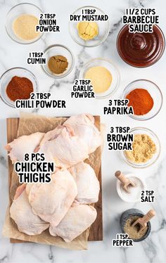 the ingredients to make chicken thighs on a cutting board