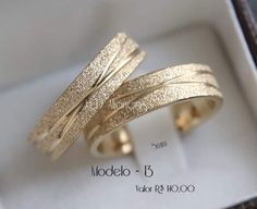 two gold rings in a box with the words modelo - 5 written on them