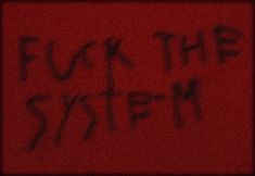 graffiti written on the side of a red wall that says, f k the system