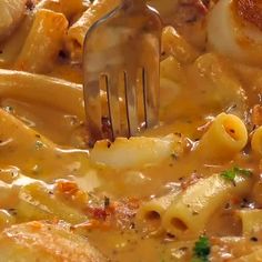 a fork is stuck into some pasta with cheese