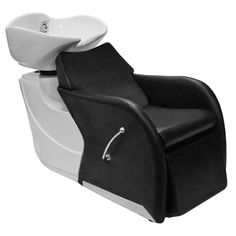 a black and white reclining chair sitting next to a sink