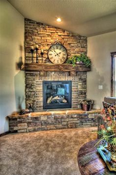 a living room filled with furniture and a fire place under a clock mounted on the wall