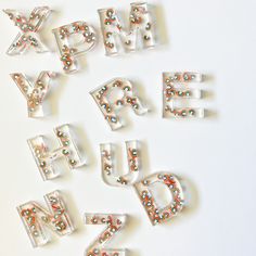 the letters are made out of plastic and have sprinkles on them,