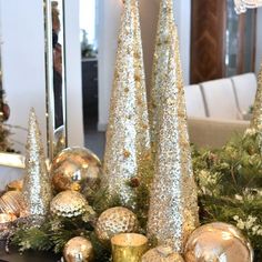 gold and silver christmas decorations on a table