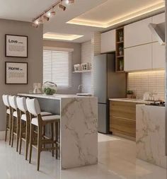 a modern kitchen with marble counter tops and bar stools