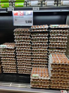 there are many trays of eggs on the shelf in the grocery store for sale