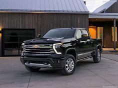 a black truck parked in front of a house