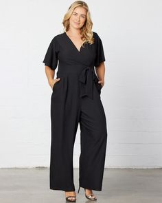 Jump from work to a wedding on the weekend in our Charisma Crepe Jumpsuit. Designed with a surplice neckline, short flutter sleeves and a detachable tie at the waistband. Pleated detail at the front and back of pant adds a tailored appearance. A zipper in the back makes getting in and out a breeze. The ideal jumpsuit for any occasion, you'll love this one and done style. Jumpsuit And Cardigan, Chic Cardigan, One And Done, Crepe Jumpsuit, Evening Gown Dresses, Surplice Neckline, Black Tie Wedding, Plus Size Jumpsuit, Jumpsuit Fashion