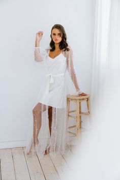 Our most luxurious robe yet. Luxe tulle is encrusted with faux pearl detailing which delicately flows across the body. The romantic billowing sleeves have an elasticised cuff, and the robe is tied at the front with a waistband. Our pearl encrusted robe is perfect for the bride and those getting ready photos. Details: Pearl tulle maxi robe overlay Optional matte white satin slip White waist tie Cuffs with button Exclusive to Miss Poppy Design Dusty Rose Wedding Theme, Bride Dressing Gown, Bride Pajama, Kimono Gown, Reception Outfit, Getting Ready Photos, Dusty Rose Wedding