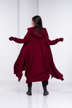 "Wool Cape, Knit Cardigan, Cloak with Hood This asymmetrical and modern cloak with hood has two side pockets, super comfy hood and thumb holes for a fabulous look. The model in the picture is 168cm. ⅼ 5.6 ft. tall and is wearing size S / color: burgundy 🌟 INFO: * Worldwide EXPRESS shipping - please provide a phone number for shipping documents * US Sizing XS to 4XL - size chart available below - all measurements of the body * We offer customization to Personal Measurements & Larger Sizes 5X Cloak With Hood, Gilet Kimono, Wool Cape Coat, Cardigan Kimono, Long Knit Cardigan, Wool Cape, Hooded Cloak, Loose Knit Sweaters, Black Tunic